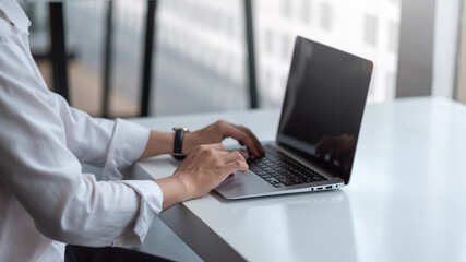 Close up of businessman working By typing on the laptop keyboard at the office