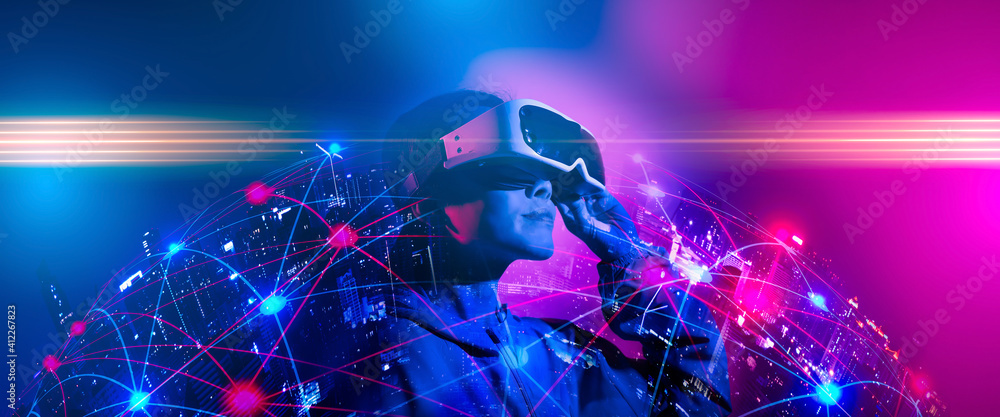 Young woman using glasses of virtual reality on dark background. Smartphone using with VR headset,virtual reality,future technology concept.Asian woman using VR glasses in colorful neon lights. - obrazy, fototapety, plakaty 