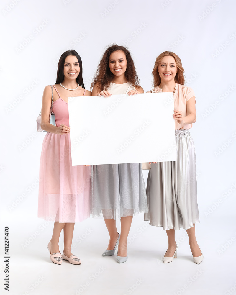 Beautiful women with blank poster on white background. International Women's Day celebration