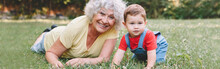 Grandmother With Grandson Boy At Home Backyard. Bonding Of Relatives And Generation Communication. Old Woman With Baby Having Fun Spending Time Together Outdoors. Web Banner Header.