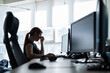© Михаил Решетников - Tired woman workaholic t-shirt works in an empty office and holds fingers on the bridge of the nose. A girl with a headache works overtime. Female silhouette on a window background. Problems at work.