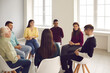 © Studio Romantic - Getting psychological help in a friendly atmosphere. Happy smiling diverse people sitting in circle and listening to young man talking about his concerns and sharing opinion in a group therapy session