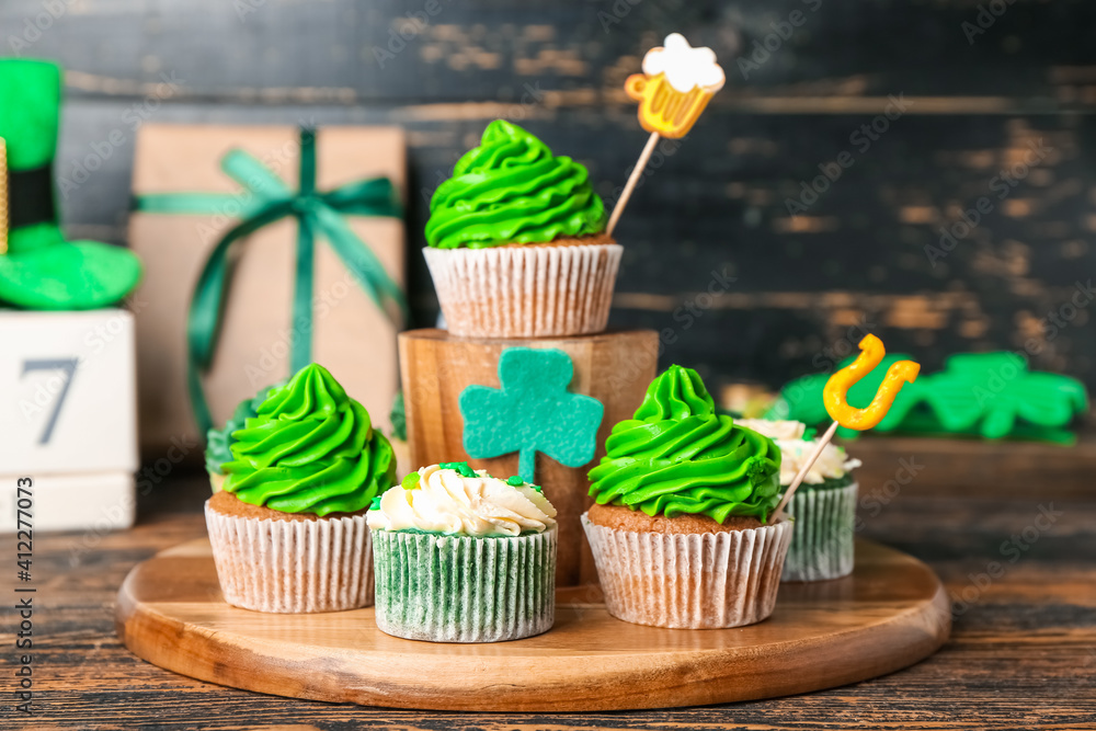 Tasty cupcakes for St. Patrick's Day on wooden background