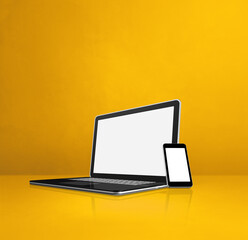 Wall Mural - Laptop and mobile phone on yellow office desk