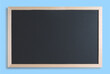 © LeticiaLara - Black chalkboard with wood border and blue background