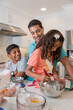 © RZCREATIVE/Stocksy - Father baking in modern kitchen with his son and young daughter.