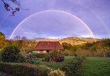 Fototapeta Tęcza - Double and complete rainbow over country house with the Triano Mountains in the background