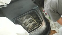 Woman Spray Painting RV Interior Black. Close Up Shot As Hand Uses Sprayer To Paint The Part Of The Motor Vehicle’s Cab.