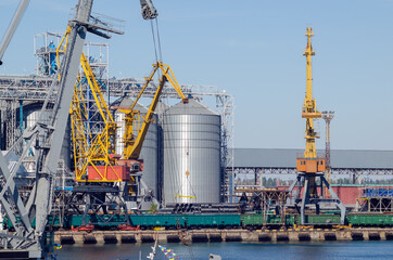 Lifting harbor cranes, shipping containers and granaries in the cargo seaport