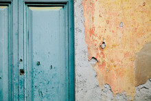 Turquoise Door And Orange Plaster Wall
