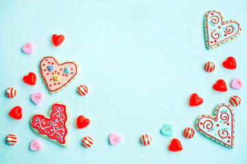 Sticker - Homemade heart-shaped decorated cookies and sweet candies on a light blue background with copy space