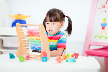 young  girl learn counting by using abacus for homeschooling
