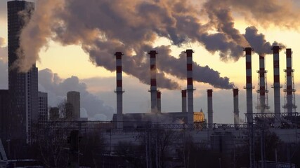 Wall Mural - industrial landscape, the pipes of the thermal power plant at sunset