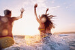 © Aila Images/Stocksy - Three Friends swimming in the sea at Sunrise