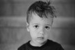 © Jakob Lagerstedt/Stocksy - Grumpy looking young boy with messy hair
