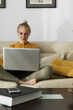 © Milles Studio/Stocksy - Beautiful girl chilling with gadget on sofa