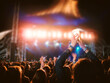 © Marcel/Stocksy - Cheering concert crowd at night