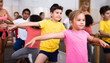 © JackF - Group of boys and girls training along ballet bar at dance class