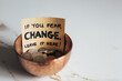 © Gourmet Photography/Stocksy - Copper bowl with coins with sign 'If you fear change, leave it here'