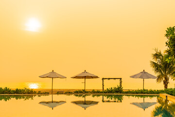 Sticker - Umbrella and chair around outdoor swimming pool in hotel resort