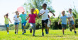 © JackF - Group of happy kids with balloons running in race and laughing in park