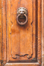 Lion Head Knocker On An Old Wooden Door