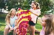 © Sean Locke Photography/Stocksy - Tie Dye: Girl Holds Up Spiral Dyed Shirt