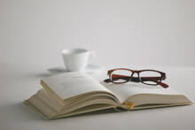 Book, Glasses And Coffee Cup On The Table. White Background.