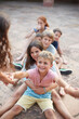 © MIQUEL LLONCH/Stocksy - Group of children playing together a game of strength