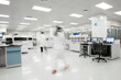 © MaaHoo Studio/Stocksy - BLurred motion of scientists walking in a lab