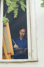 Young Female Artist Working In Her Studio