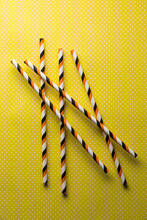 Straws And Yellow Polka Dot Background.