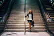 © Jayme Burrows Photography/Stocksy - Young, Professional Woman Walkign Down Stairs.