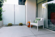© Luke Mattson/Stocksy - White Chair And Back Patio Of Private Resort Hotel Room