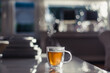© Cindy Prins/Stocksy - A glass cup of tea with steam standing on a table in the sunlight