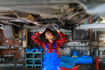 Wall Mural - African Female auto mechanic working at the repair shop.