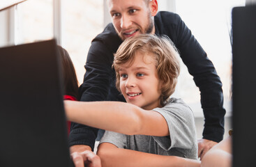 Wall Mural - schoolkid and teacher discussing study project on laptop