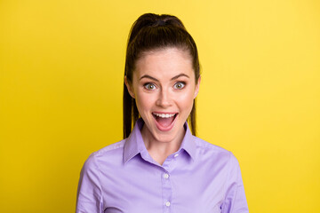 Wall Mural - Photo of excited young lady open mouth look camera wear purple shirt isolated yellow color background