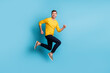 © deagreez - Full body profile photo of satisfied person running jumping toothy smile isolated on blue color background