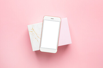 Wall Mural - Pink and marble gift present box and mobile phone on pastel pink background