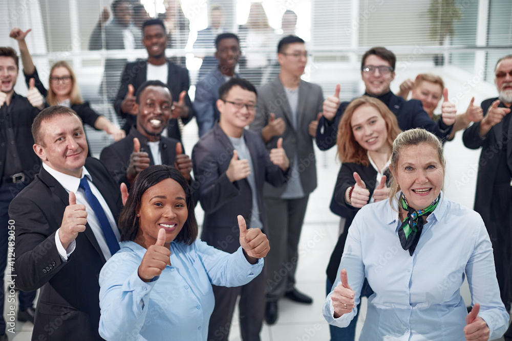 group of diverse co-workers giving a thumbs up . - obrazy, fototapety, plakaty 