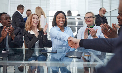 Wall Mural - smiling businesswoman shaking hands with her business partner.