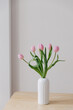 © Joske - Pink tulips in a white vintage vase in a European Scandinavian styled interior.
