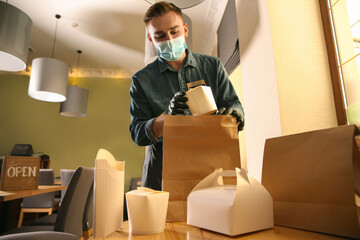 Sticker - Waiter packing takeout order in restaurant. Food service during coronavirus quarantine