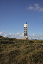 Vertical Shot Of  Isolated Punta Frouxeira Lighthouse In Galicia Spain On  Background Of Blue Sky