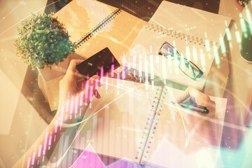 Multi exposure of woman on-line shopping holding a credit card and financial graph drawing. Stock market E-commerce concept.