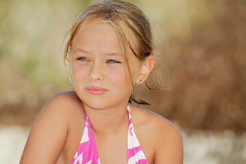 Wall Mural - Little blonde girl in swimsuit on the beach