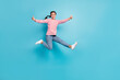 © deagreez - Full body photo of young excited girl happy smile jump up show thumb-up like advice cool isolated over blue color background