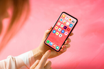 Woman viewing home screen with app icons of the mobile phone