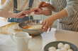 © stciel - Happy adorable little child girl in apron enjoying cooking homemade pastry together with grandmother at home.